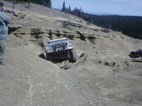 1978 Ford Bronco - A 4x4 vehicle navigates a challenging off-road trail with a second vehicle visible in the distance.