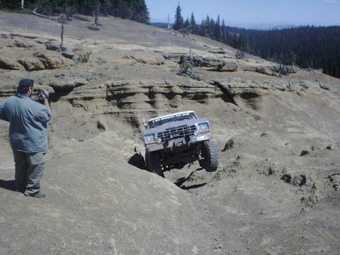 1978 Ford Bronco - A 1978 Ford Bronco tackles a challenging off-road course, its suspension articulation on a steep, rocky hill.