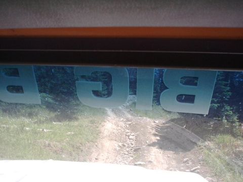 1978 Ford Bronco - Dirt road visible through a window with a 'BIG' decal, suggesting an off-road adventure.