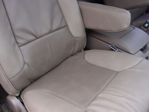 1992 Ford Bronco - Interior view of tan leather seats and center console.