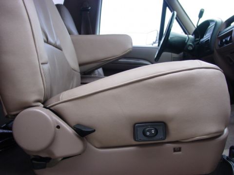1992 Ford Bronco - Interior view of a 1992 Ford Bronco, highlighting the tan leather captain's chair with visible power controls.