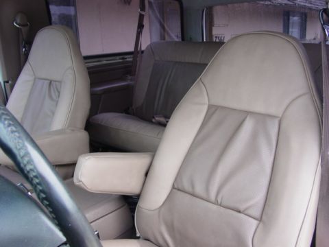 1992 Ford Bronco - Interior view of tan leather bucket seats and a rear bench seat in a 1992 Ford Bronco.