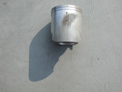 1985 Ford Bronco - Engine piston shown on a textured surface.