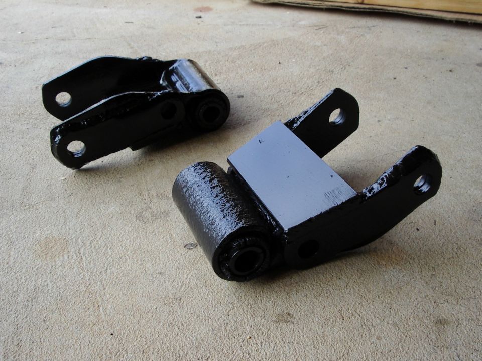 Factory shackles reinforced with trailer spring shackles on the side, and plate on the back.