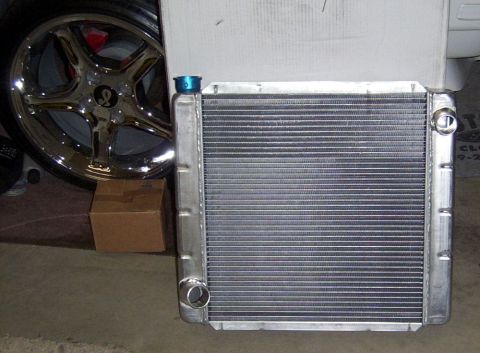 1978 Ford Mustang II - A new radiator is shown next to a chrome wheel, possibly for a custom build or restoration project.
