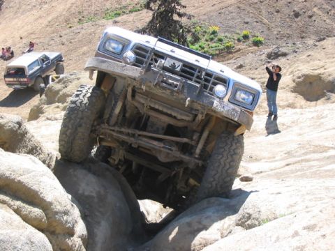 1995 Ford Bronco - This vehicle is navigating a difficult rocky terrain, with another SUV visible in the background.