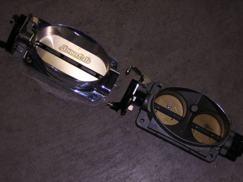 1992 Ford Crown Victoria - Close-up of Accufab throttle body parts on a dark surface.