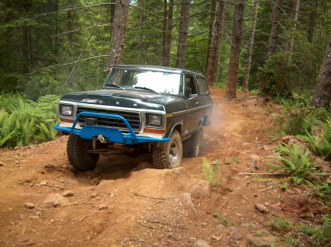 1978 Ford Bronco - This 1978 Ford Bronco navigates a rocky, wooded trail, demonstrating its off-road capabilities.