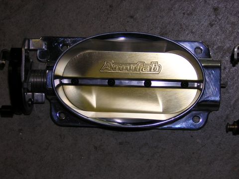 1992 Ford Crown Victoria - A close-up view of an Accufab throttle body, a component of a vehicle's engine system.