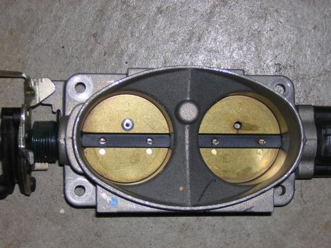 1992 Ford Crown Victoria - A close-up view of a dual throttle body assembly, likely from a V8 engine.