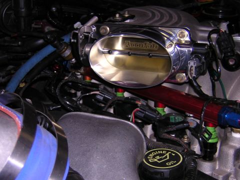 1992 Ford Crown Victoria - Engine bay detail showing an aftermarket throttle body and fuel system components.