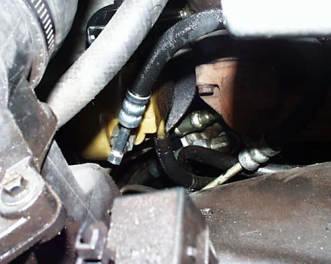 1988 Ford C-350 (Centurion Conversions) - Engine bay hoses and connections are visible in this close-up shot.