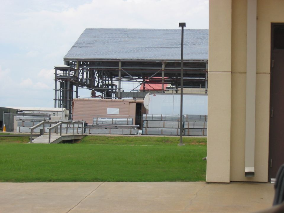 Construction site with stacked materials and unfinished building structure