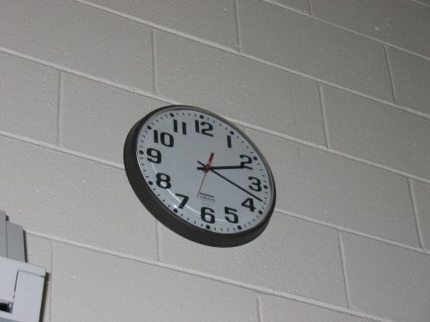 1988 Ford Bronco - A wall clock hangs on a white brick wall, showing the time as approximately 2:15.