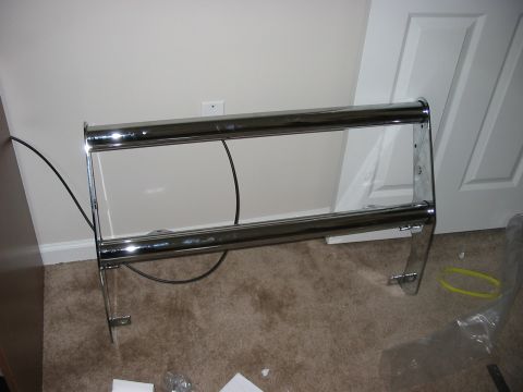 1988 Ford Bronco - Chrome bull bar part shown indoors, not attached to a vehicle.