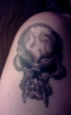1995 Ford Bronco - A tattoo of a skull with fangs is visible on skin.