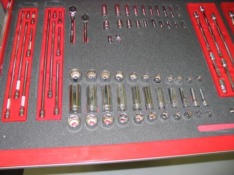 1988 Ford Bronco - A collection of various sockets and ratchets are neatly organized in a tool chest drawer.