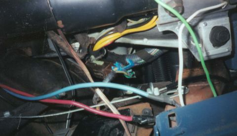 1987 Ford Bronco - Tangled wiring harness with multiple colored wires visible under the dashboard.