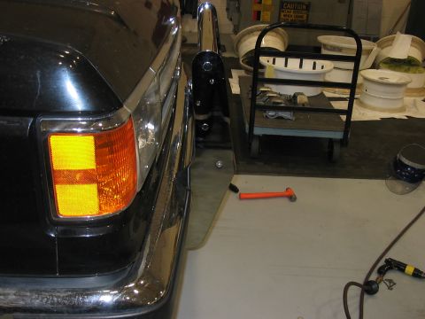 1988 Ford Bronco - Rear corner of a black SUV with a chrome bumper and amber turn signal is visible.