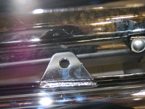 1988 Ford Bronco - Close-up of chrome trim and a mounting bracket, with Supermotors.net logo.