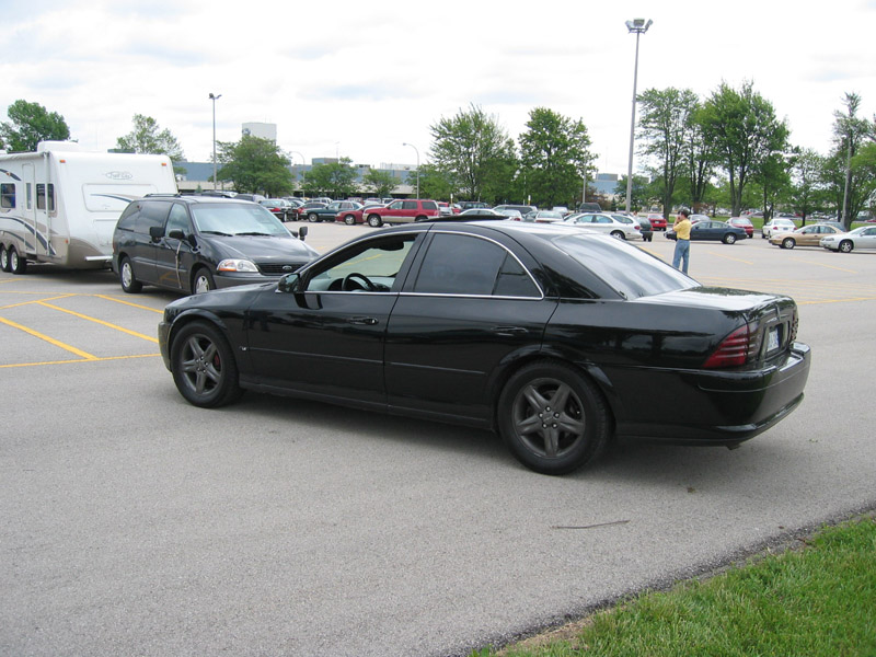 Black Lincoln LS sedan with tinted windows and dark alloy wheels in a parking lot