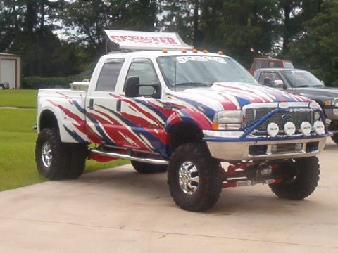 1980 Ford Bronco - This lifted pickup truck features patriotic graphics and a 'SkyJacker' sign.
