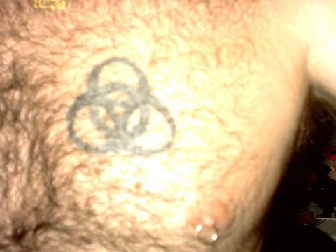 1995 Ford Bronco - A tattoo of interlocking rings is visible on a person's chest.