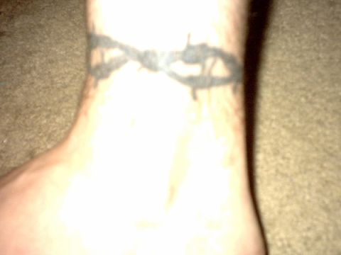 1995 Ford Bronco - Close-up of a barbed wire tattoo on a person's wrist.