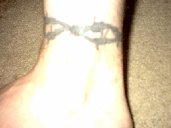 Tattoo of barbed wire design on a wrist