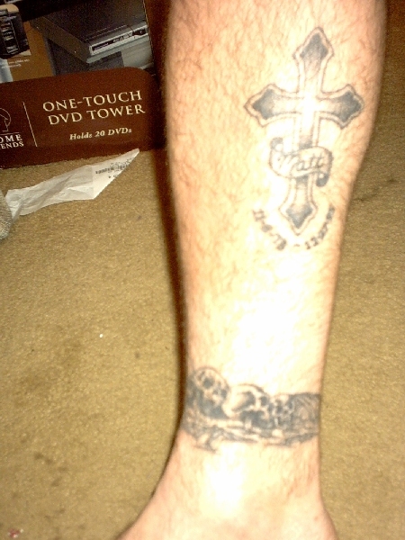 1995 Ford Bronco - A tattoo of a cross with a banner reading 'Matt' is visible on a leg, next to a DVD tower.