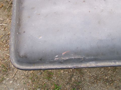 1967 Ford Bronco - This close-up shows a gray metal panel with visible wear and tear, including scratches and chipped paint.