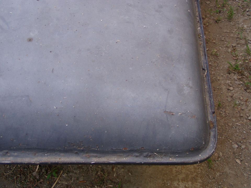 Overhead close-up of the chalky gray corner and drip rail of a removable hardtop