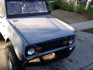 1967 Ford Bronco - A gray 1966 Ford Bronco is shown from the front, in need of restoration.