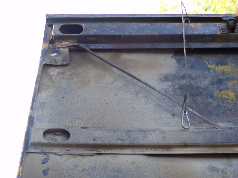 inside of a tailgate with a cable and carabiner clip