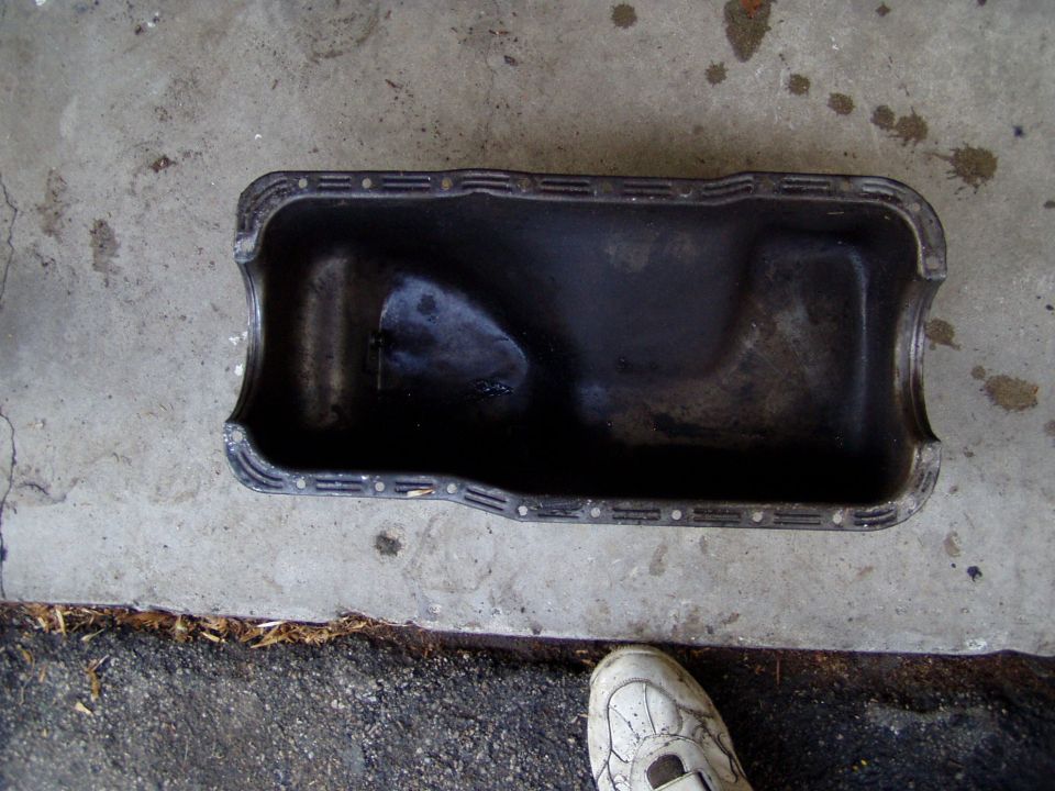 Oil pan sitting on a concrete surface