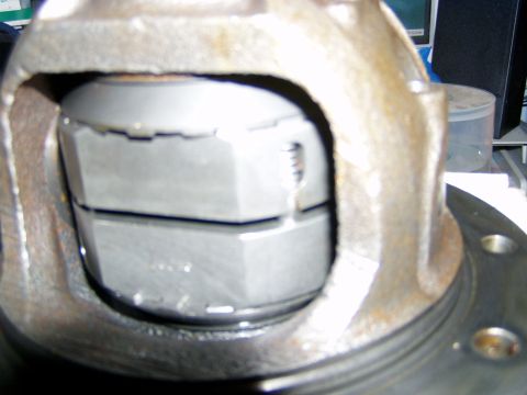 1985 Ford Bronco - This image shows a close-up view of a differential gear assembly, focusing on a large hex nut within the housing.