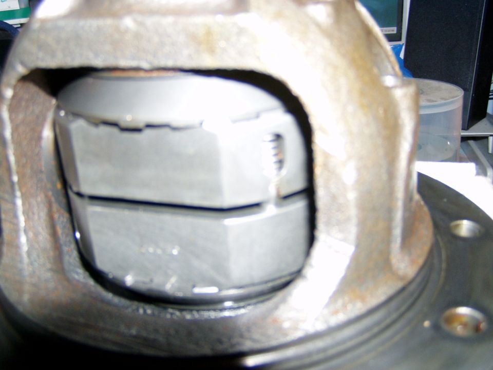 Locker mechanism installed inside a rusty differential carrier, close-up