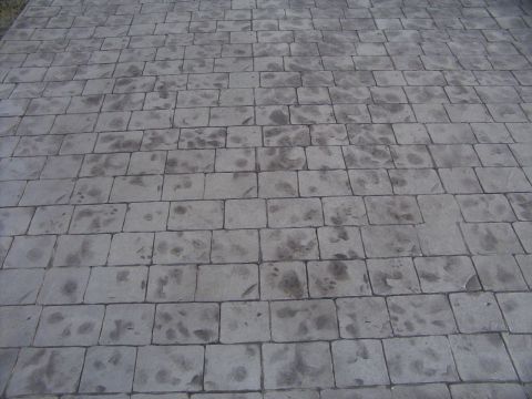 1995 Ford Bronco - A stamped concrete patio with irregular dark stains is shown from a high angle.