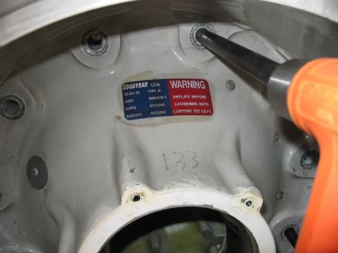 1988 Ford Bronco - A warning label on a Goodyear wheel hub assembly part indicates specific maintenance procedures.