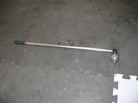 1988 Ford Bronco - A torque wrench and socket are shown on a gray floor mat.