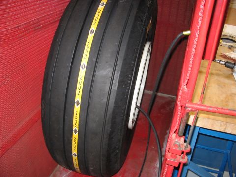 1988 Ford Bronco - A tire with a yellow stripe repeated "2002" markings is shown mounted on a rim.