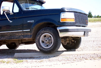 1995 Ford Bronco - Front quarter view of a 1995 Ford Bronco, parked on a concrete stop in a gravel lot.