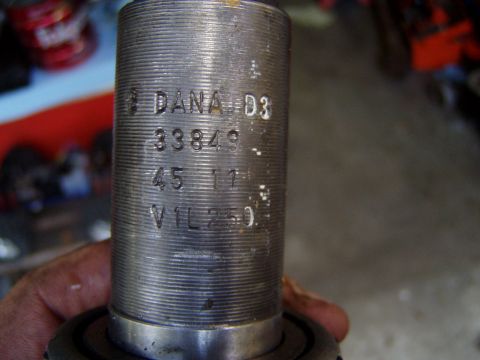 1985 Ford Bronco - Close-up of a metal part stamped with DANA D3 and other numbers, held by a hand.