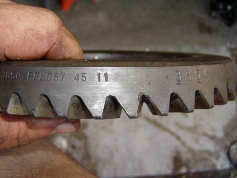 1985 Ford Bronco - Metal gear part with stamped identification numbers visible.