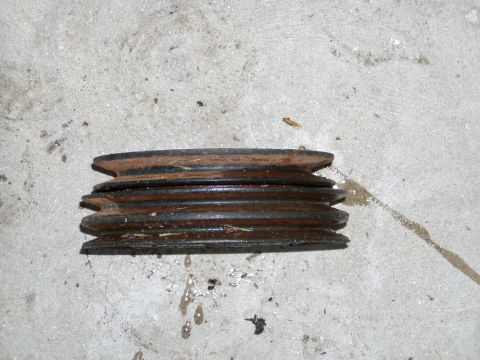 1967 Ford Bronco - This is a multi-groove pulley, likely from an engine, shown on a concrete floor.