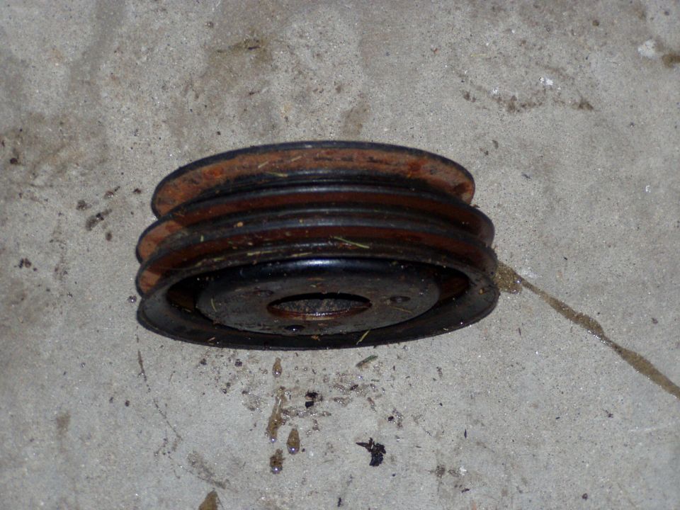 worn pulley with two grooves on concrete