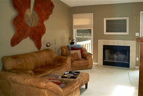 1985 Ford LTD Crown Victoria - A living room scene a large decorative wall hanging and a fireplace.