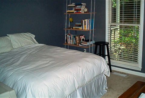1985 Ford LTD Crown Victoria - A bedroom scene includes a bed, a bookshelf, and a window with blinds.