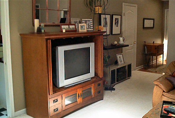Interior scene with a wooden entertainment center and television