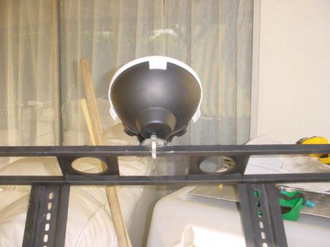 1988 Ford Bronco - Off-road light assembly attached to a metal rack, with wooden poles in the background.